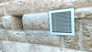 A closeup of a dual outlet subfloor extractor with Solar Whiz Subfloor Ventilation system