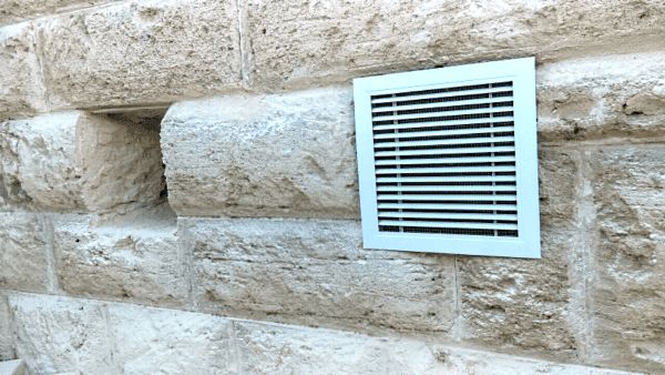 A closeup of a dual outlet subfloor extractor with Solar Whiz Subfloor Ventilation system