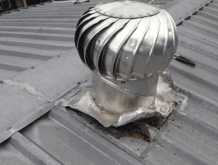 Damaged whirlybird on a roof