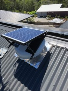 solar attic fan installed in a tin roof